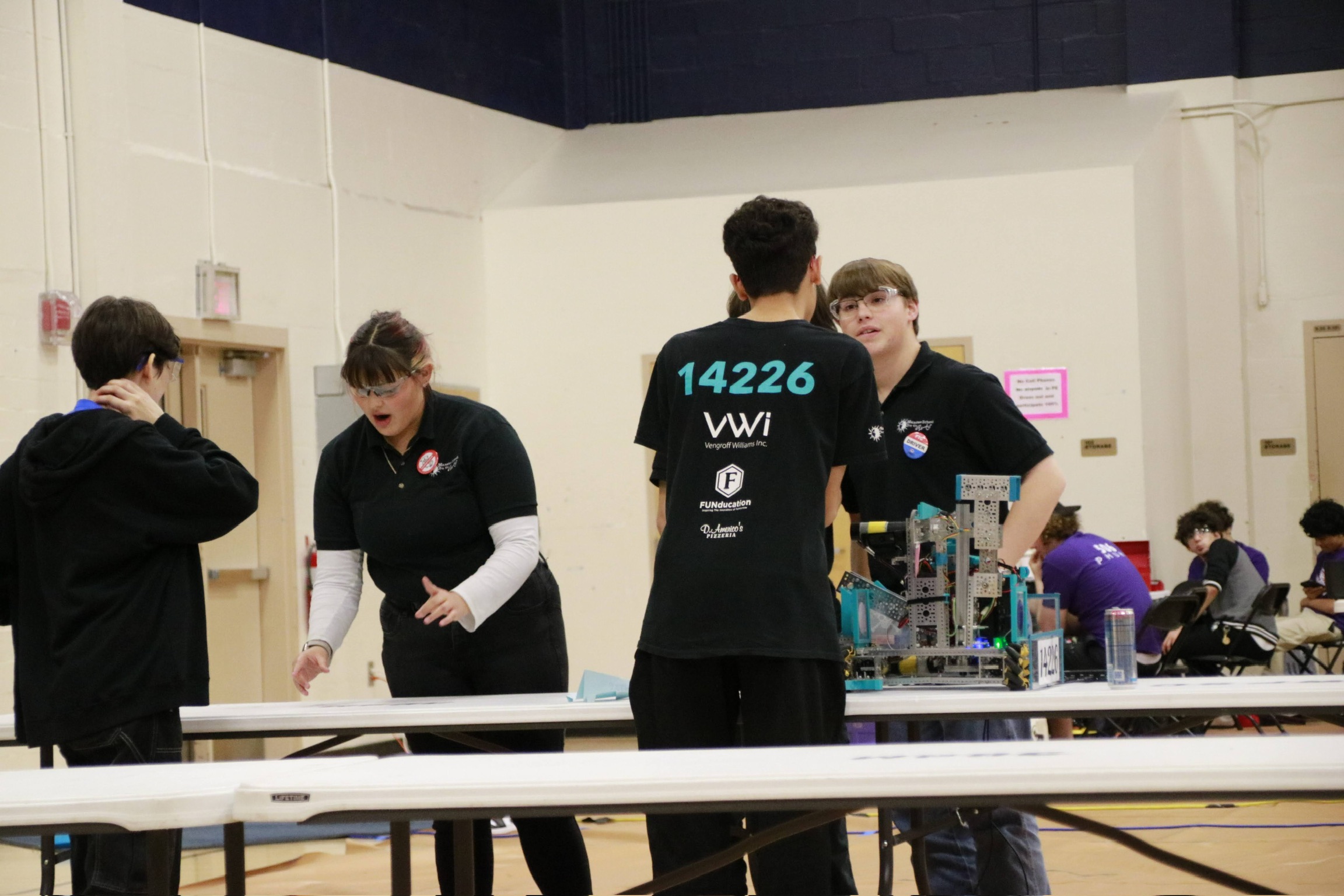 The team communicating in the queueing area at an event.